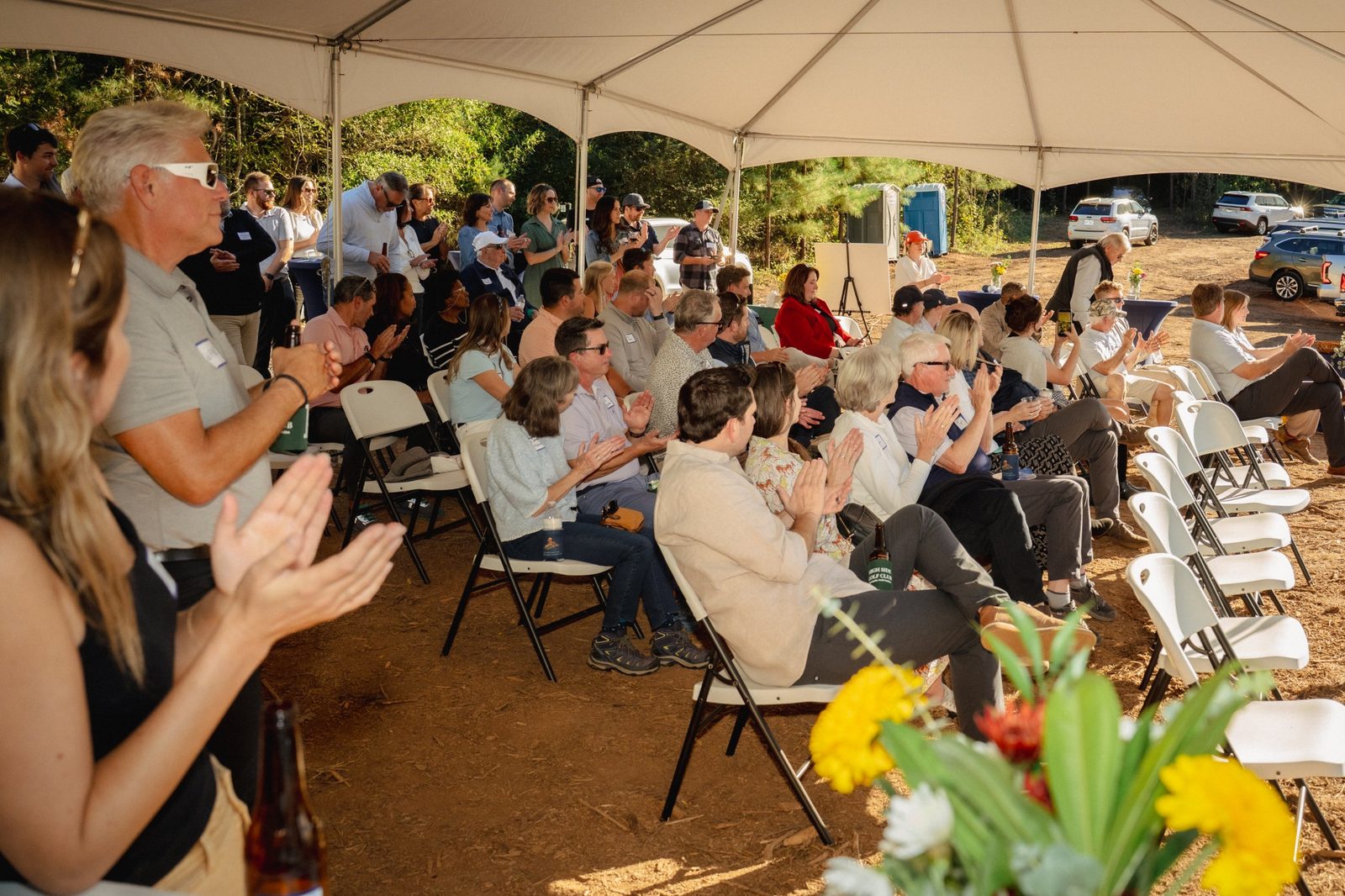 Guests applauding under the tent
