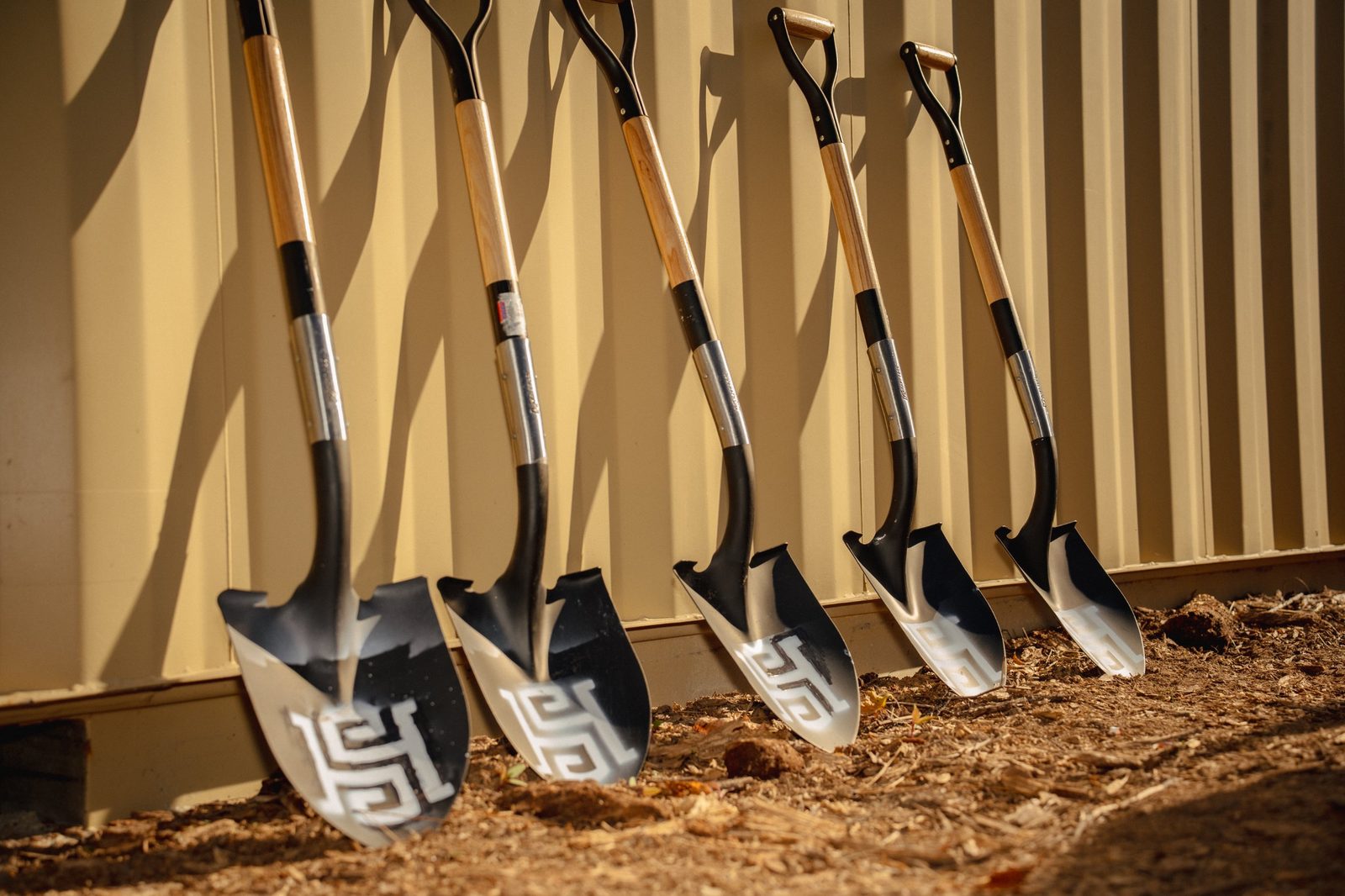 Five shovels with the High Side monogram cut into the blades
