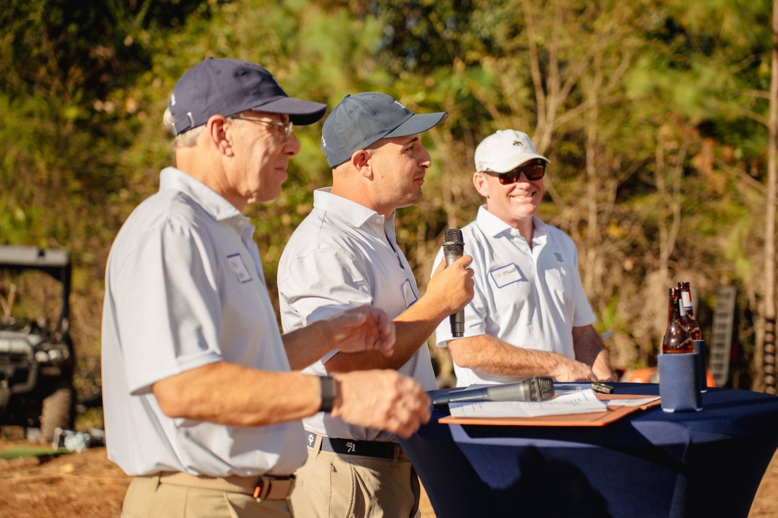 Phil Hamel, Scott Hamel and JD Downey speaking at the podium