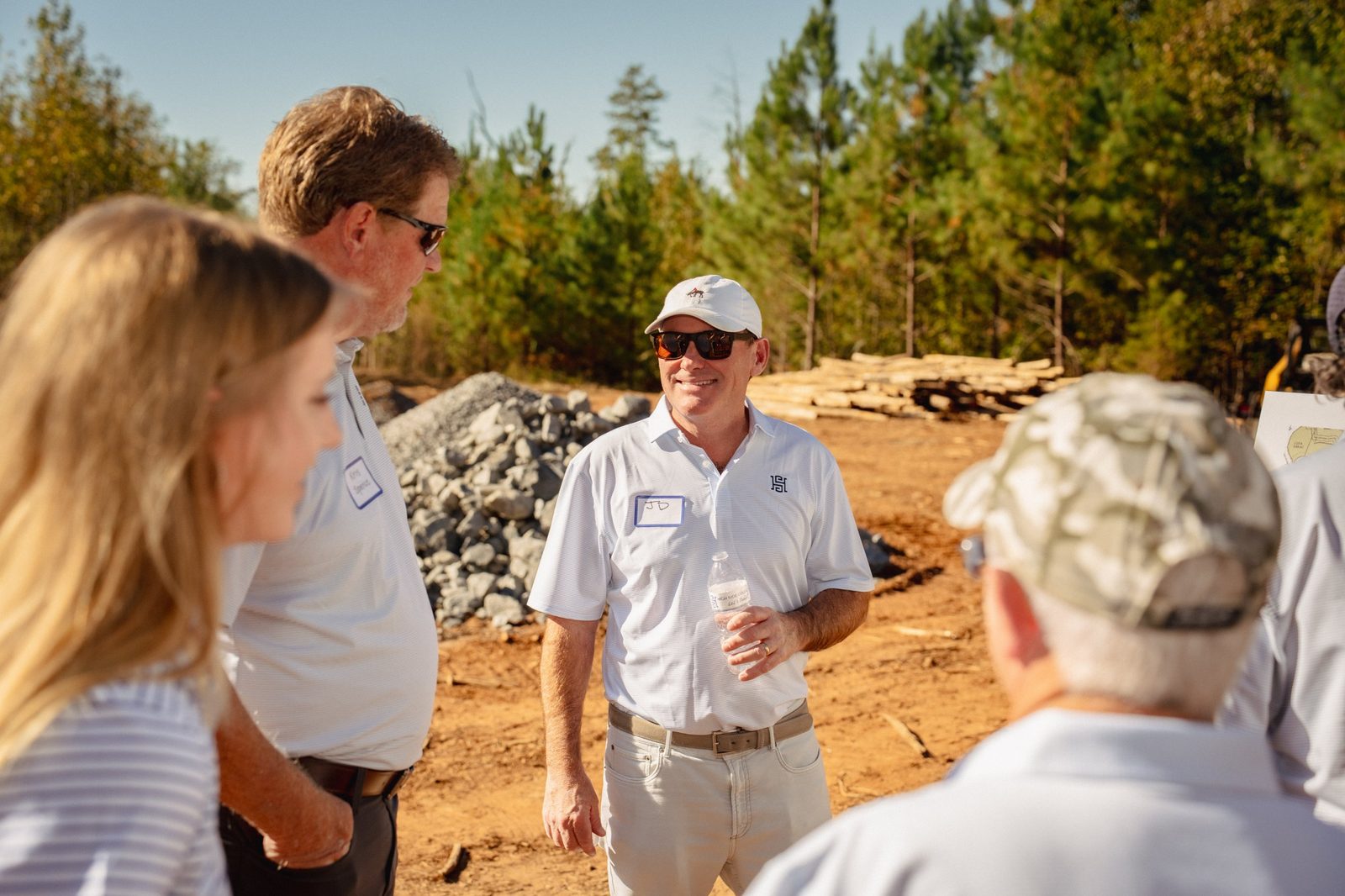 JD Downey and Kris Spence talking with guests on the land, having worked together on past projects
