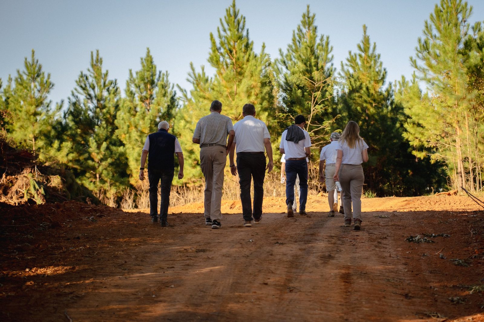 Guests walking the property on a tour through the pines